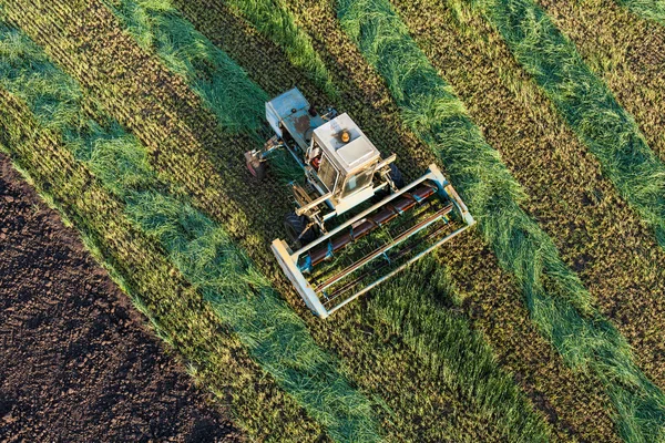 Aerial view of harvest fields with combine
