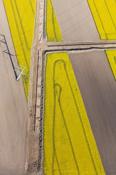 Aerial view of burying gas pipe in a country harvest fields are