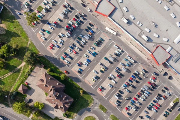 Aerial view over crowded parking lot near supermarket