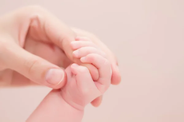 Concept of love and family. hands of mother and baby