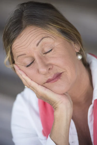 Sleepy mature woman closed eyes relaxed