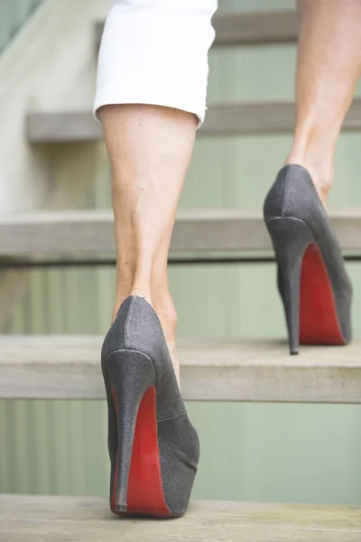 Walking up stairs in high heel stilettos