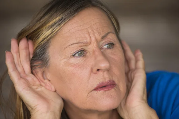 Woman listening curious to sound and noises