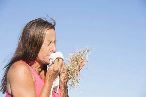 Stressed Woman suffering hay fever allergy outdoor