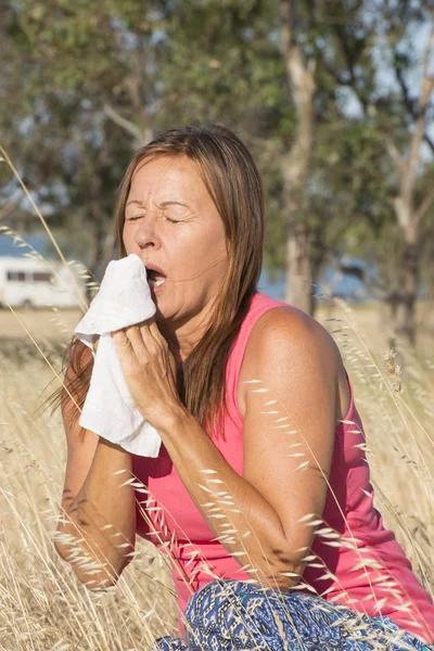Woman stressed by seasonal hayfever allergy outdoor