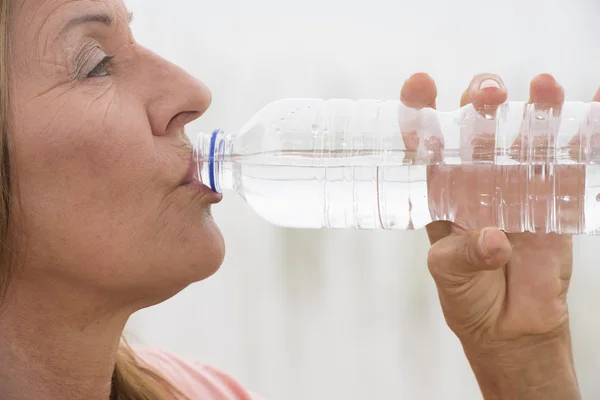Active Mature woman drinking water