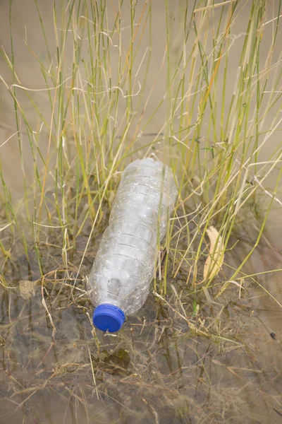 Plastic bottle garbage dumped in lake water