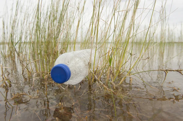 Plastic bottle garbage floating in river water