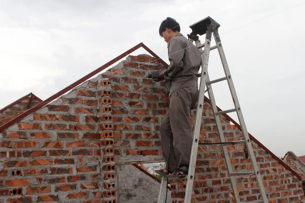 HAI DUONG, VIETNAM, JUNE, 30: workers drilling concrete on june,