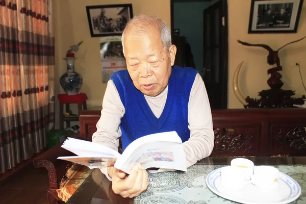 Asian old man reading