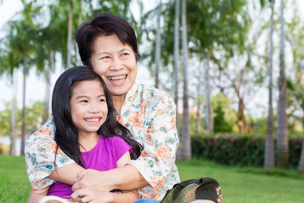 Happy asian grandma and grandchild smiling