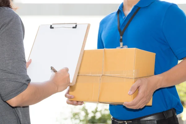Woman hand signing receipt of delivered package