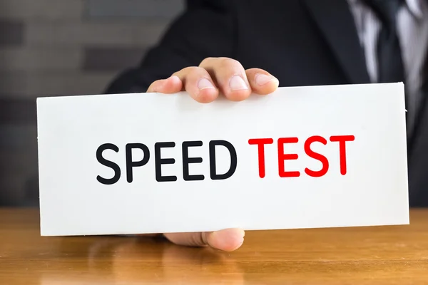 Speed test, message on white card and hold by  businessman