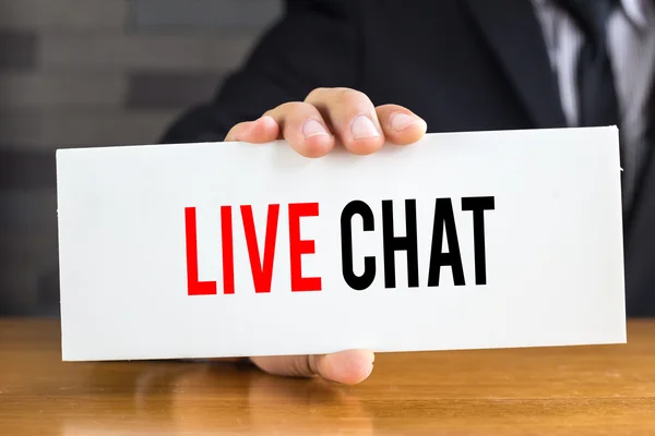Live chat, message on white card and hold by  businessman