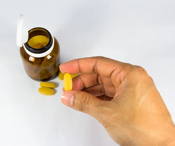 Yellow pill in hand