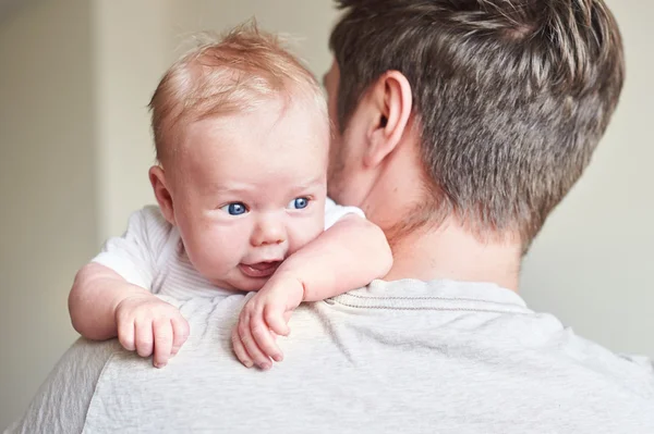 Happy father holding newborn baby in his arms