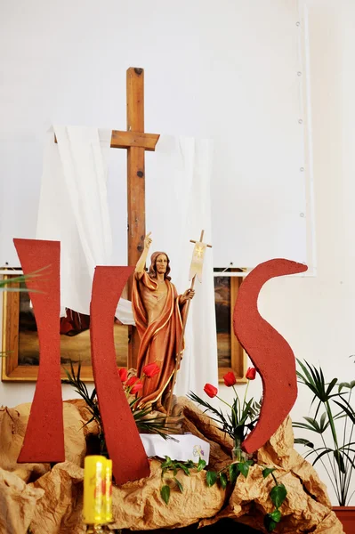 Wooden cross and Jesus figure decor in church. Easter concept