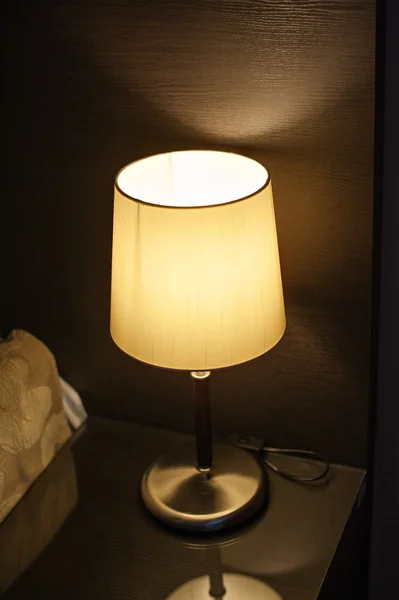 Lamp on the nightstand in the bedroom next to the bed