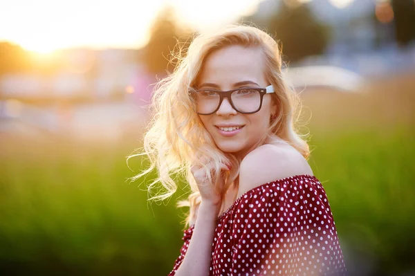 Pretty young woman in glasses posing in the park