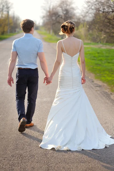 Young married couple walking on a countryside trail
