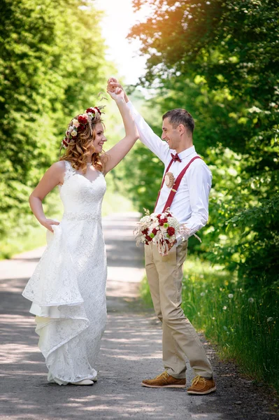 Bride and groom walking on the road