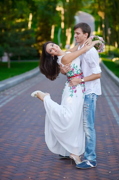 Beautiful young couple dancing in park