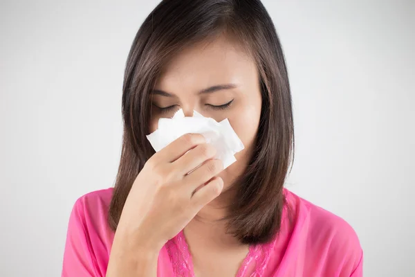 Flu cold or allergy symptom. Sick woman girl sneezing in tissue
