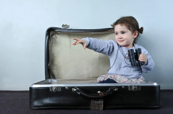 Traveler child in a travel suitcase