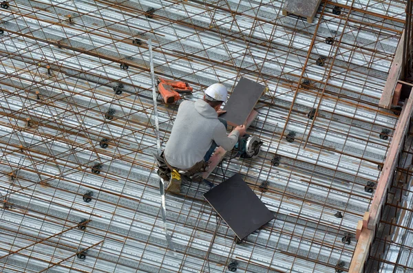 Roofer construction worker works in a construction site