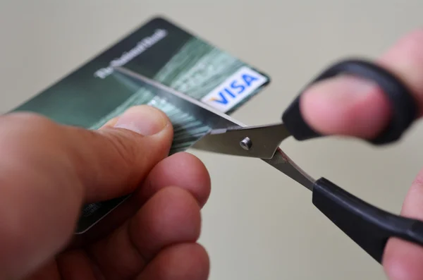 Man hands cut creditcard with scissors