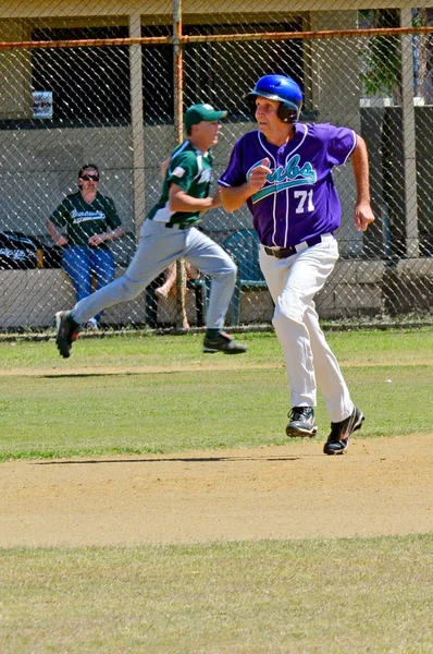 Man plays baseball in the park