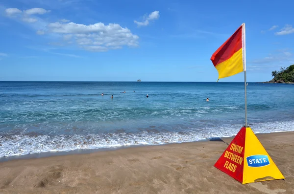 Red and yellow flag near sea