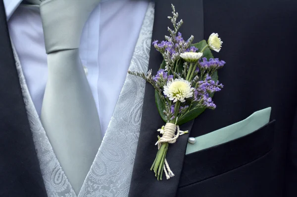 Corsage boutonniere brooch on groom suit