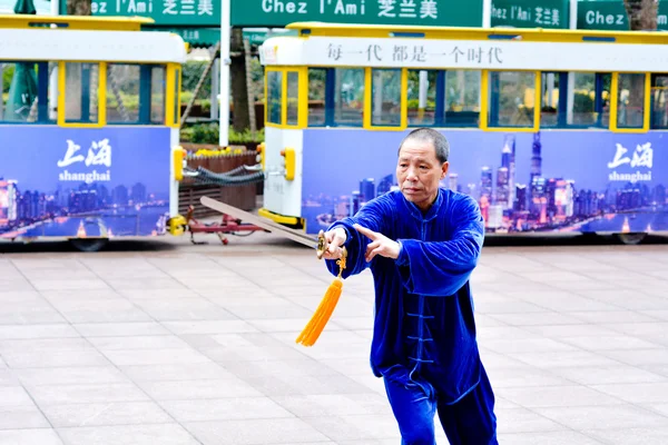 Chinese man practice Tai Chi in Nanjing Road Shanghai China