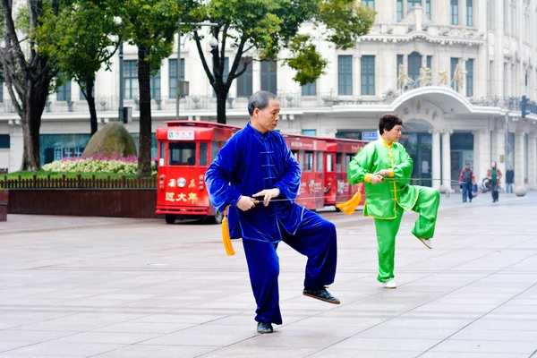Chinese couple practice Tai Chi in Nanjing Road Shanghai China