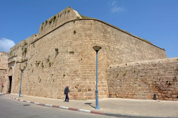 Arab man walks under the walls