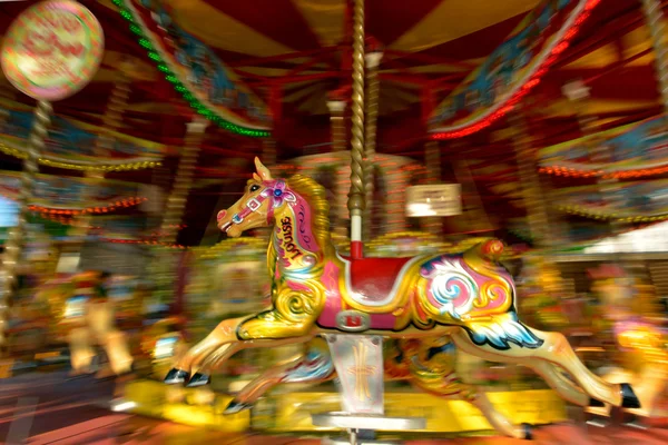 Motion blurr of vintage horse of amusement ride on merry-go-roun