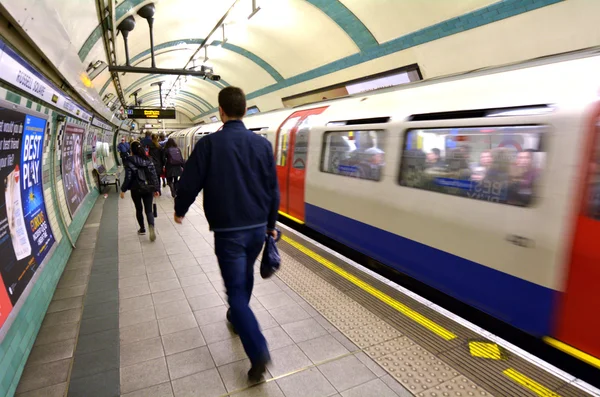 Passengers travel on  London Underground platform