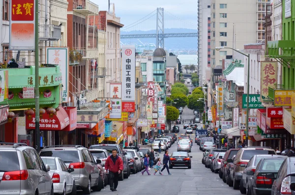 Chines people and Oakland bay bridge as seen from Chinatown in S