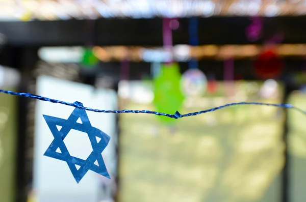 Star of David decorations inside a Jewish family Sukkah