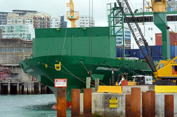 Cargo ship workers unloading containers in Ports of Auckland New