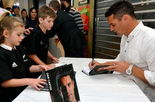 Dan Carter signing copies of his book