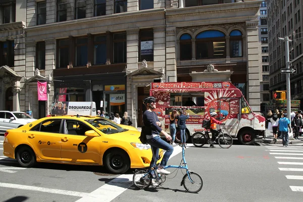 New York City Taxi and bicycle riders in Soho, Manhattan