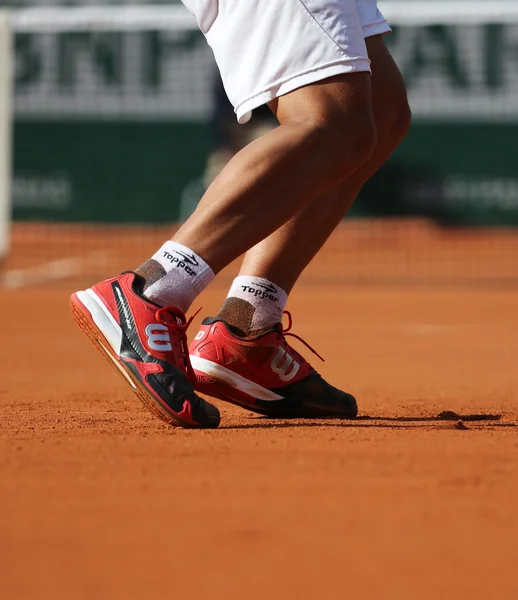 Professional tennis player wears custom Wilson tennis shoes during match at Roland Garros 2015