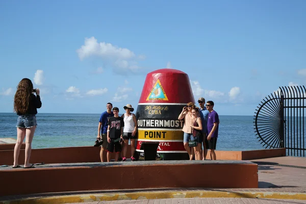 Family being photographed at the popular Southernmost Point in Continental United States