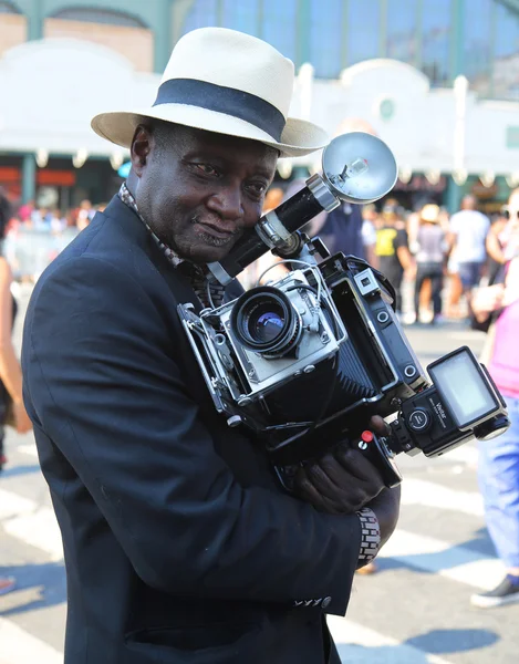 Unidentified photographer with vintage camera during the 34th Annual Mermaid Parade