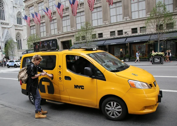 Passenger hires New York City Taxi at the Fifth Avenue in Manhattan