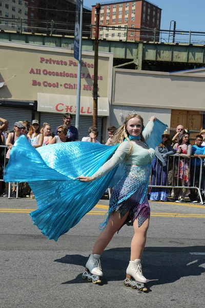 Participants march in the 34th Annual Mermaid Parade, the largest art parade in the nation