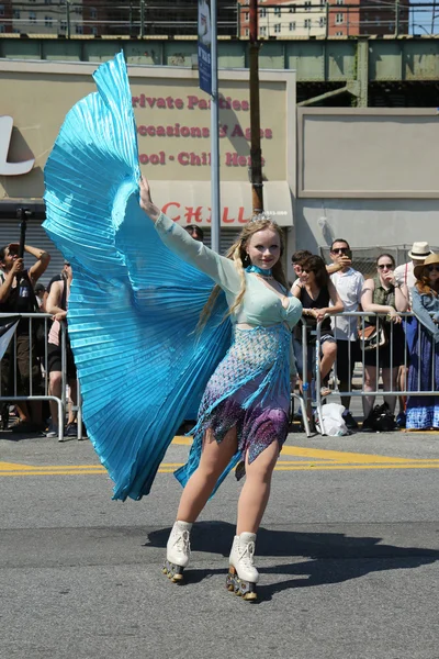 Participants march in the 34th Annual Mermaid Parade, the largest art parade in the nation