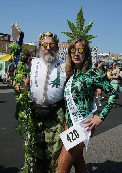 Participants march in the 34th Annual Mermaid Parade, the largest art parade in the nation